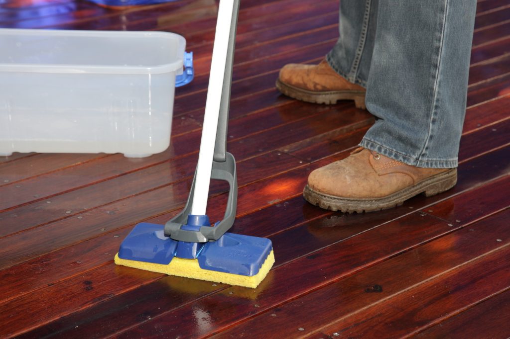 Apply Sikkens Cetol BL Deck & Wood Cleaner to wet decking boards