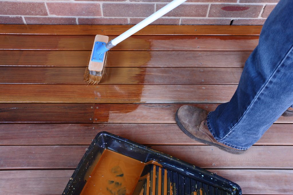 applying sikkens coating on to a deck using eezy deck brush